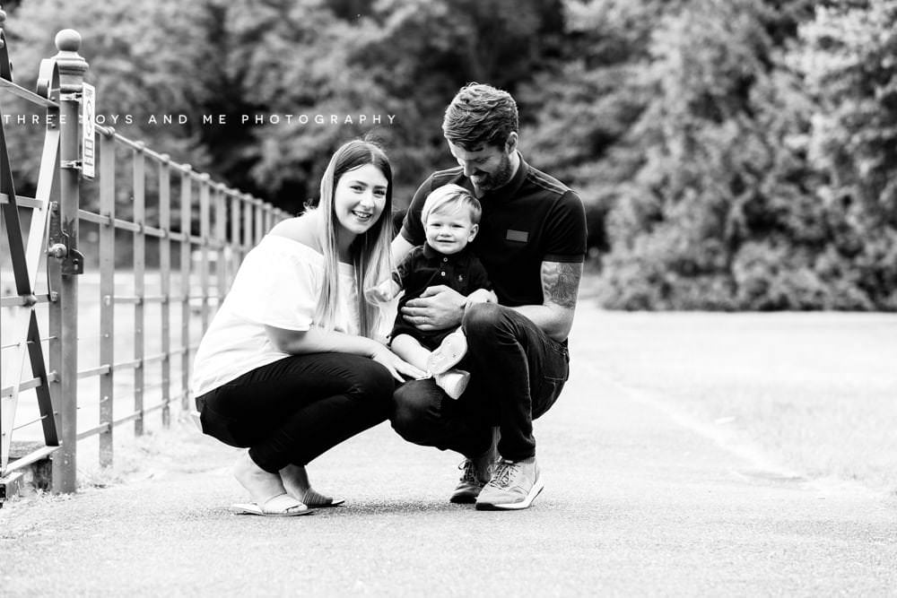 image of parents with small toddler, looking at the camera taken during their family photoshoot in Bexley Kent 