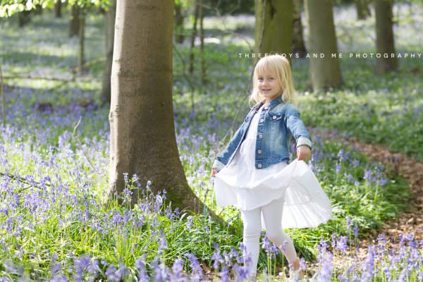 young girl twirling her white dress at her kent bluebell photoshoot in sevenoaks