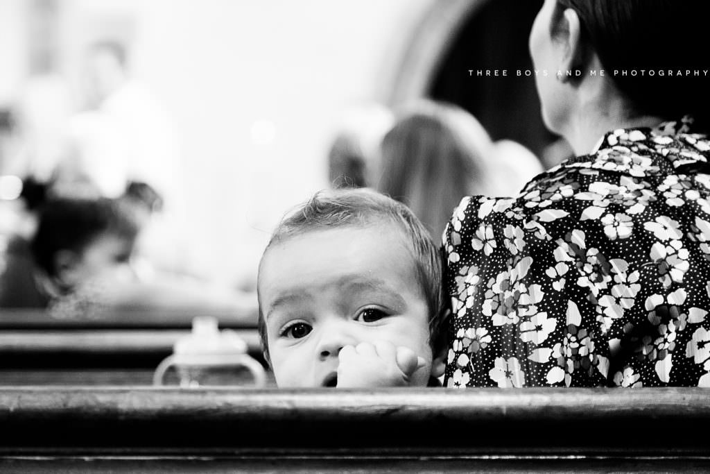 baby boy looking back over pew. kent christening photography by Nina Callow 3B&ME Photography Bexley