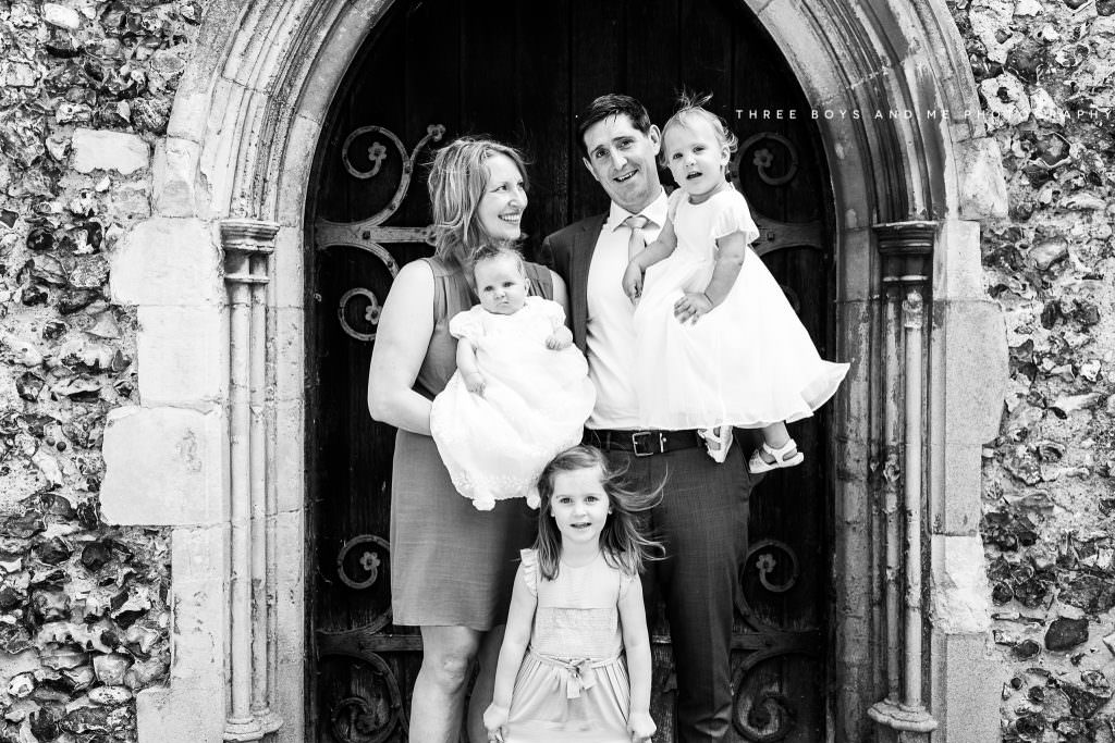 Kent Christening photography of family in church doorway at Christening in Horton Kirby photography coverage by Nina Callow 3B&ME Phtography