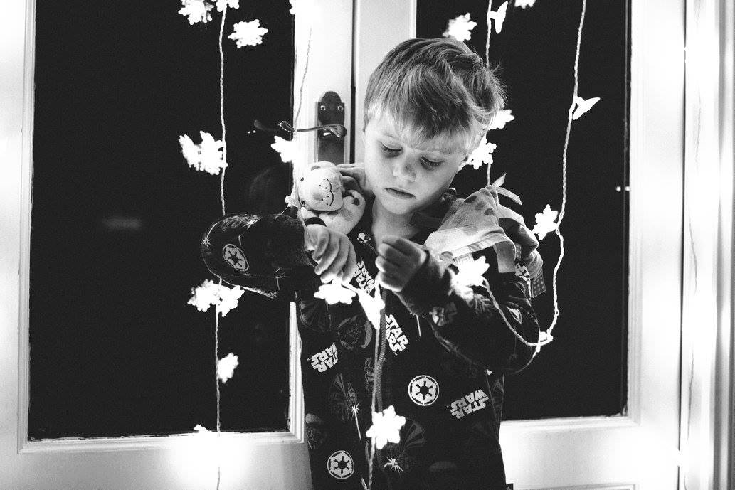 young boy playing in fairy lights Sevenoaks Family photographer 3 Boys and Me Photography