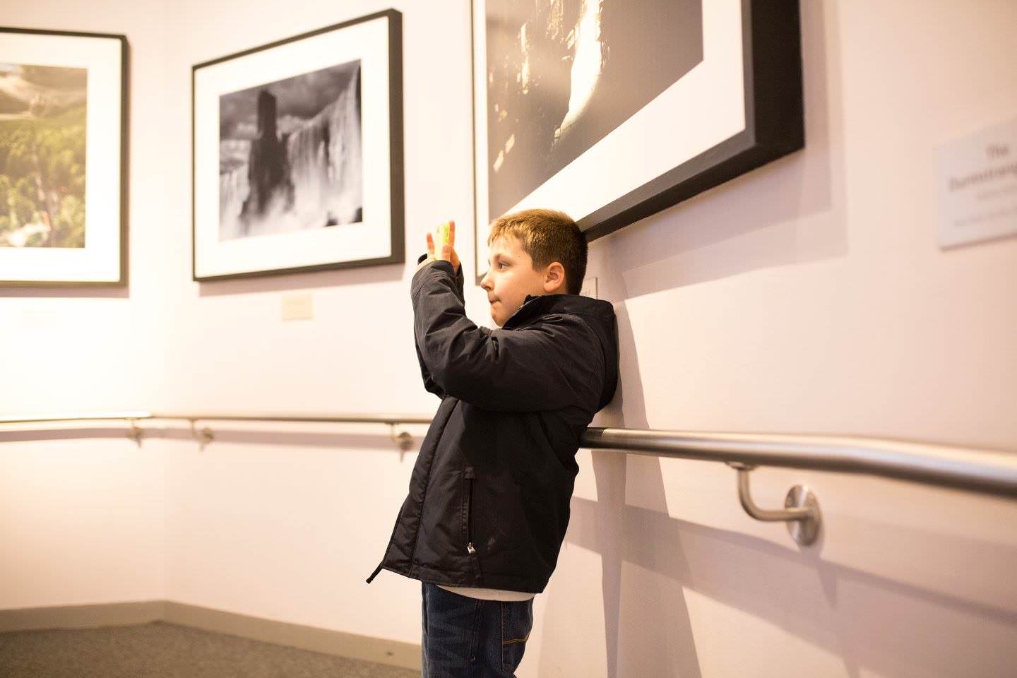 young boy taking an iPhone photograph at Harry Potter World  Sevenoaks Family photographer 3 Boys and Me Photography