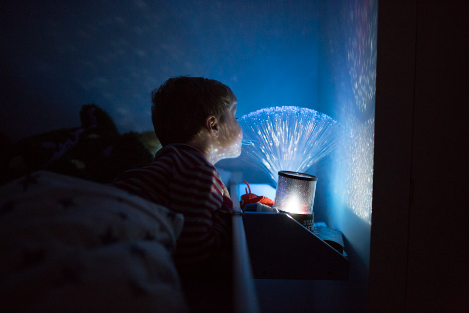 boy playing with night light in the dark Sevenoaks Family photographer 3 Boys and Me Photography