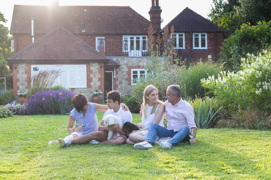 family sat on grass at their sevenoaks family photoshoot
