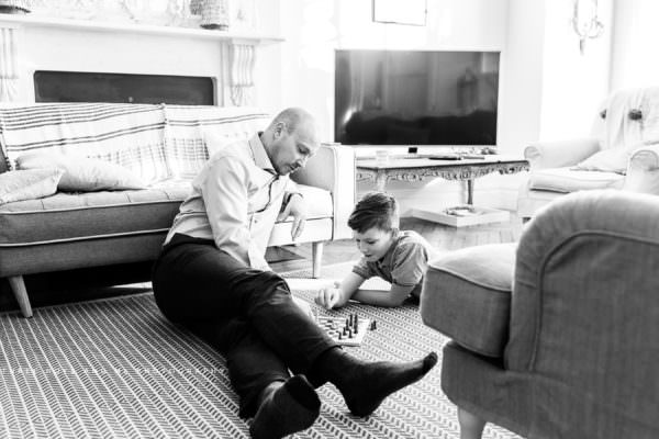 dad and son playing chess during their documentary family photoshoot in london