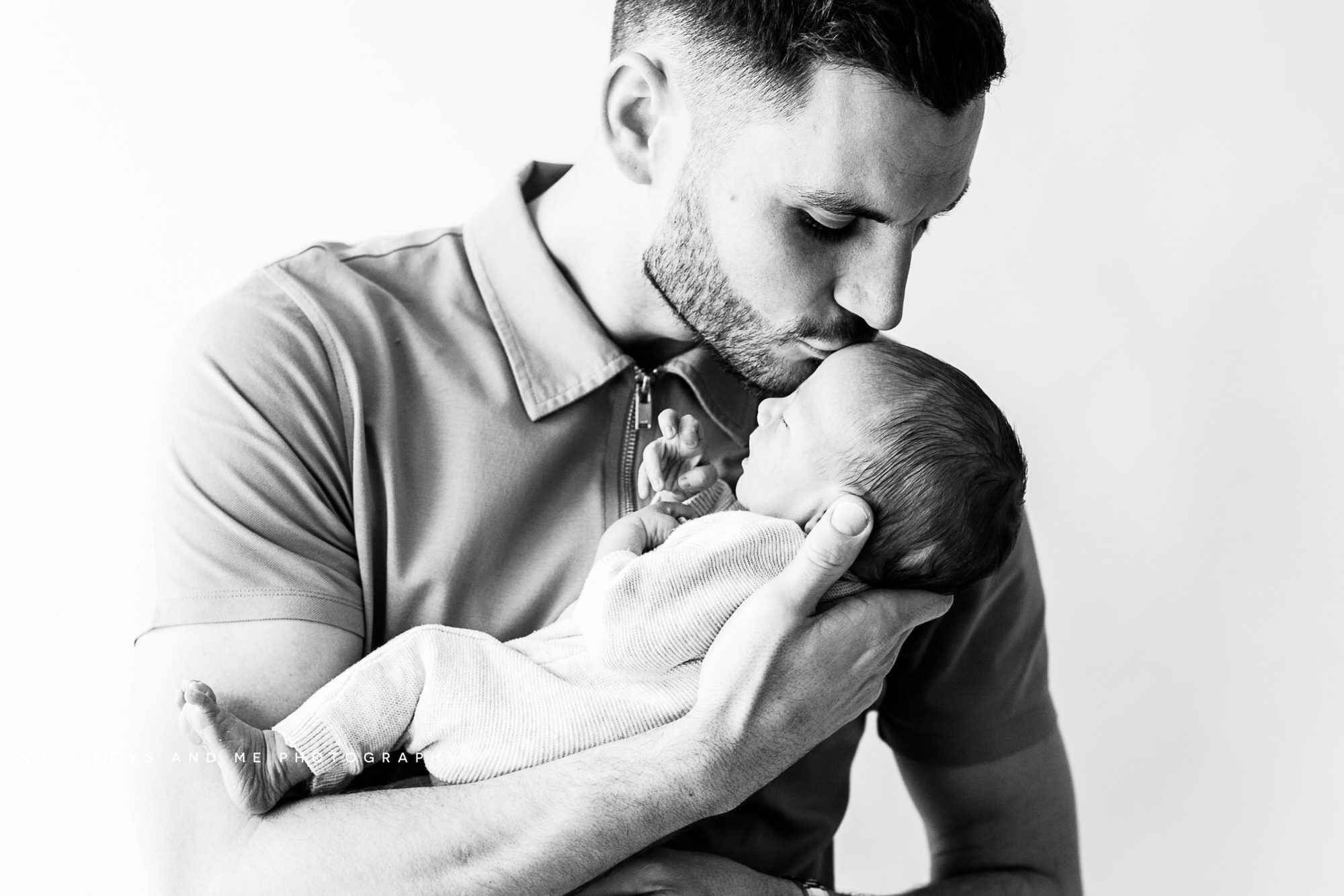 dad and newborn son black and white at his newborn photoshoot in Bexley