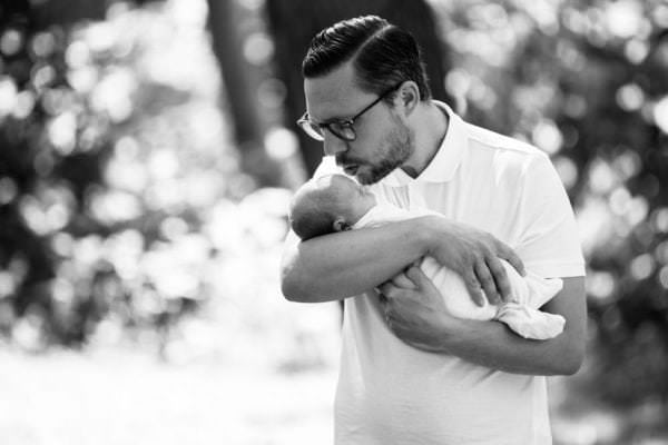 beautiful natural black and white portrait of dad and newborn daughter at their outdoor newborn photoshoot in Bexley