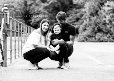image of parents with small toddler, looking at the camera taken during their family photoshoot in Bexley Kent