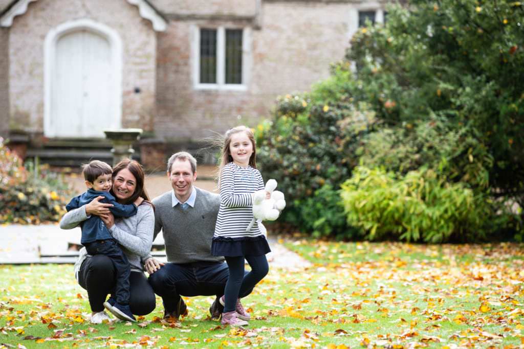 family of four in beautiful natural portrait shot during their autumn family photoshoot in Sevenoaks