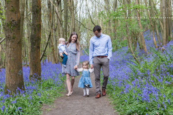 Family of 4 wandering through the bluebells at Riverhill Gardens for their Sevenoaks family photoshoot
