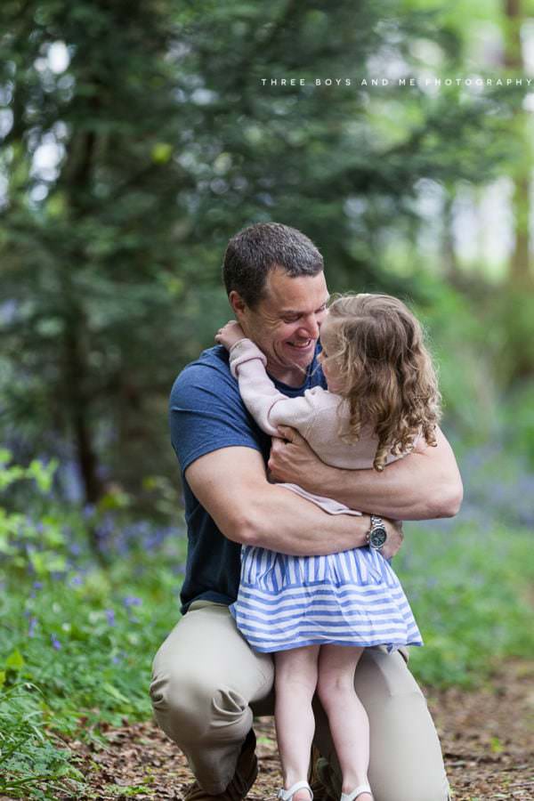 dad and daughter cuddling at their Bexley family bluebell shoot