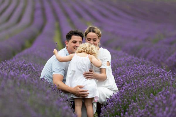 mummy daddy and little girl in the Kent Lavender fields at their lavender photoshoot