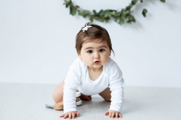 Baby girl dressed in white at her scandi style christmas photoshoot in bexley