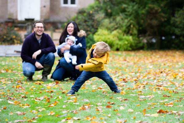 little boy dancing at his autumn family photoshoot in sevenoaks