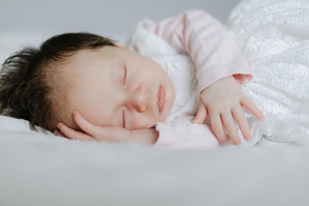 sleeping newborn baby at her newborn family photoshoot in sevenoaks