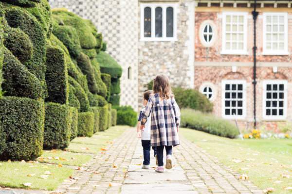 little girl and boy wwalking towards Hall Place Bexley at their bexley family photoshoot