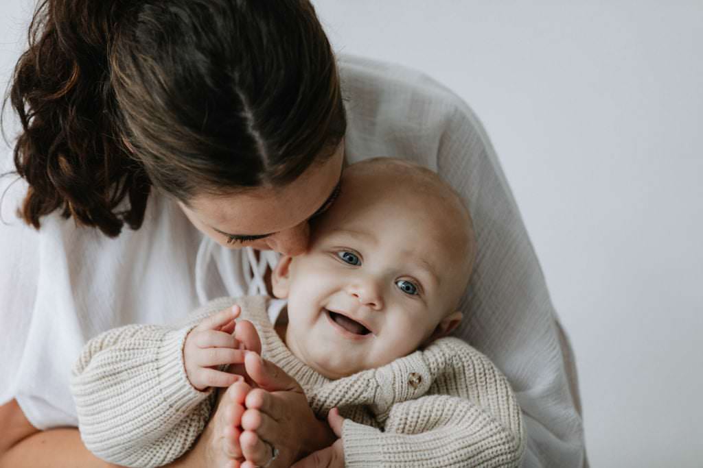 smiling baby with his mummy taken at his Bexley baby photoshoot