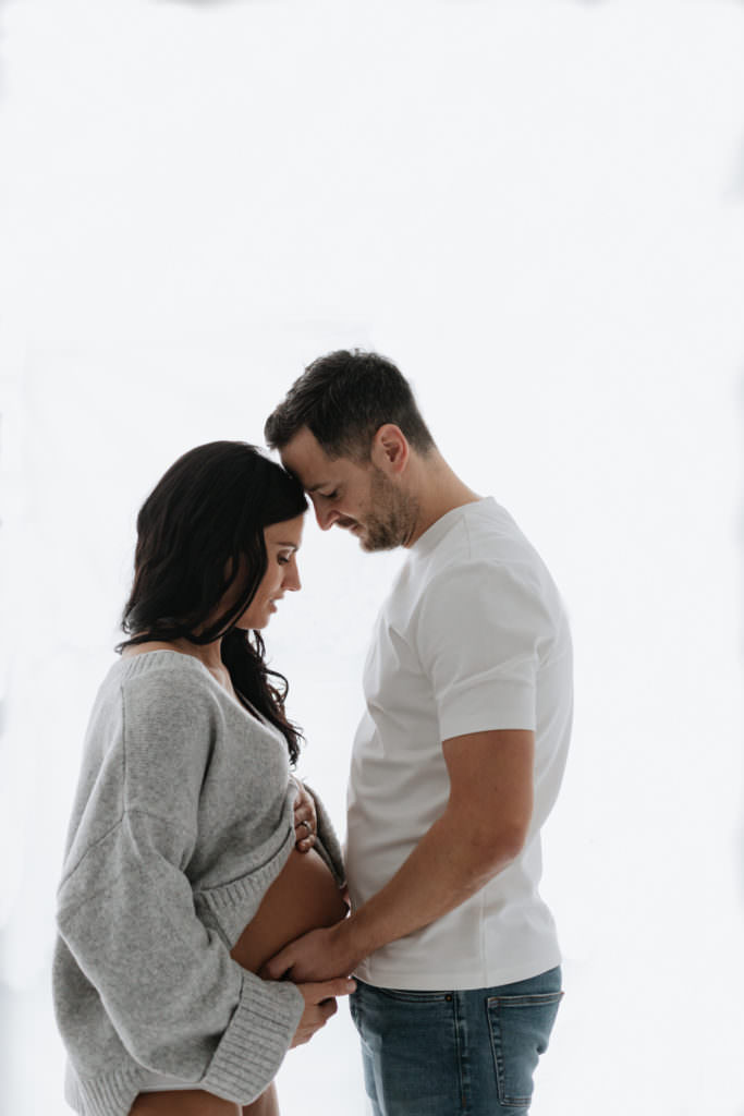 Romantic image of mummy and daddy, daddy holding baby bump at their Bexley maternity photoshoot