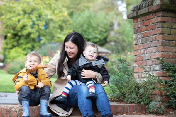 mummy and two young boys cuddling and laughing at their sevenoaks family photoshoot