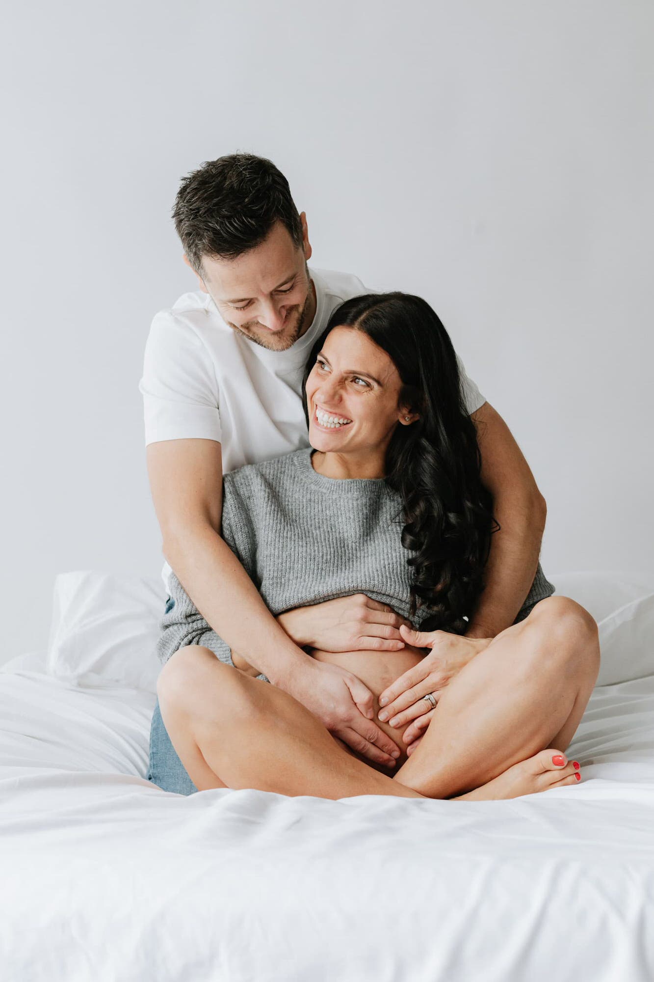 mummy and daddy to be laughing together at their kent maternity photoshoot in bexley
