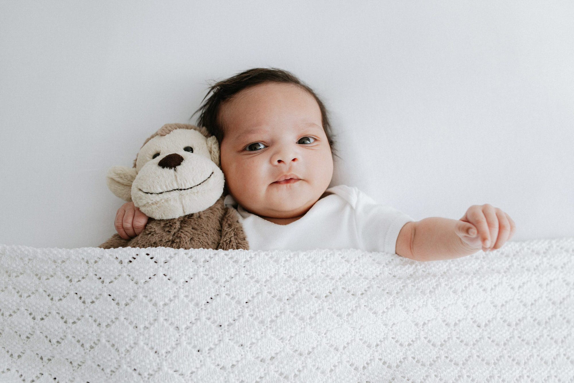 baby girl with her jellycat teddy at her kent newborn photoshoot in Bexley