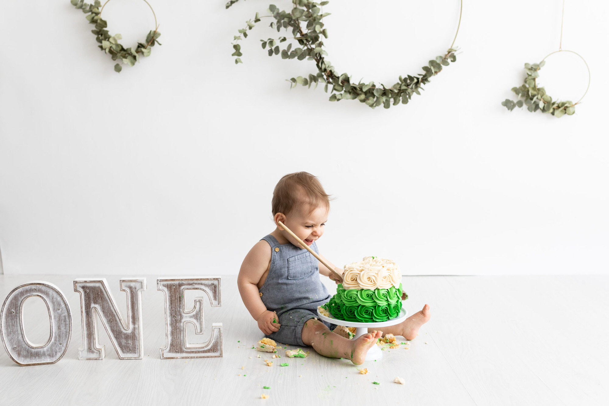 1st birthday little boy with green ruffle cake at his kent cake smash shoot in bexley