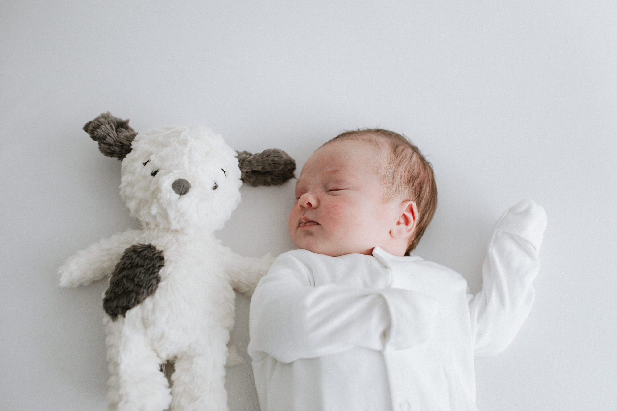 baby boy at his kent newborn photoshoot with a jelly cat teddy