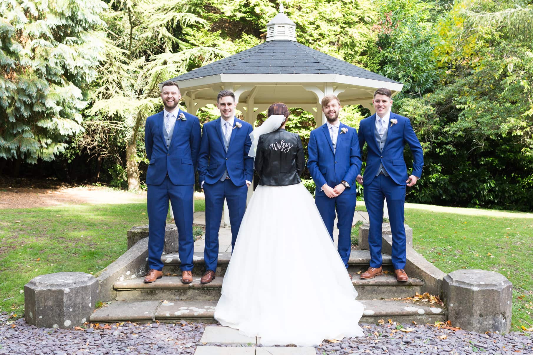 groom party with bride wearing leather wifey jacket at Selsdon estate weddings