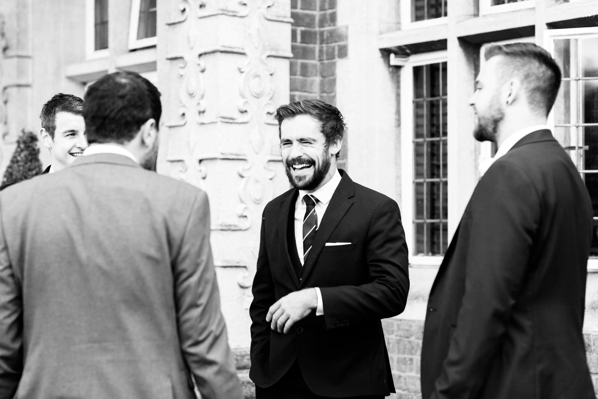 man laughing Candid image of wedding guests Selsdon Estate Weddings