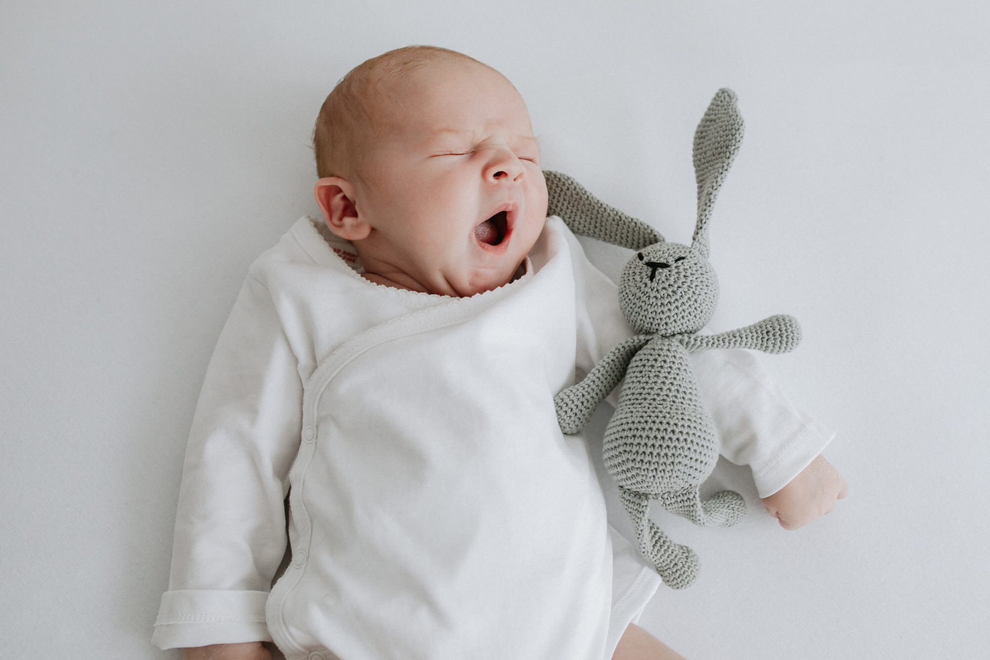 newborn baby cuddling crochet rabbit at their Kent newborn photoshoot in Bexley