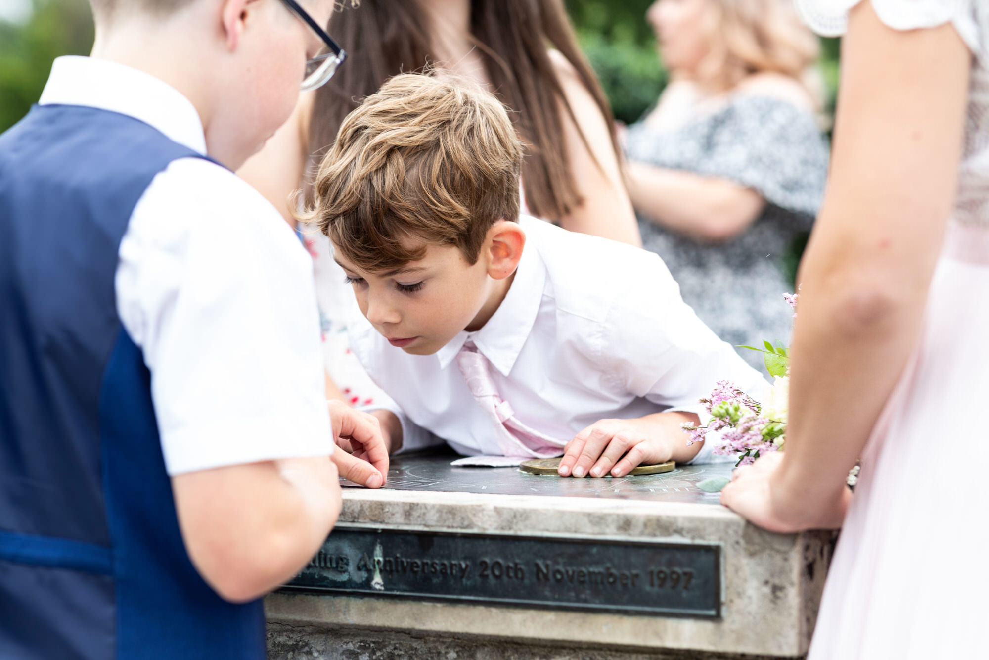 little boy looking at sundial shot at Kent micro wedding at Danson House Bexleyheath