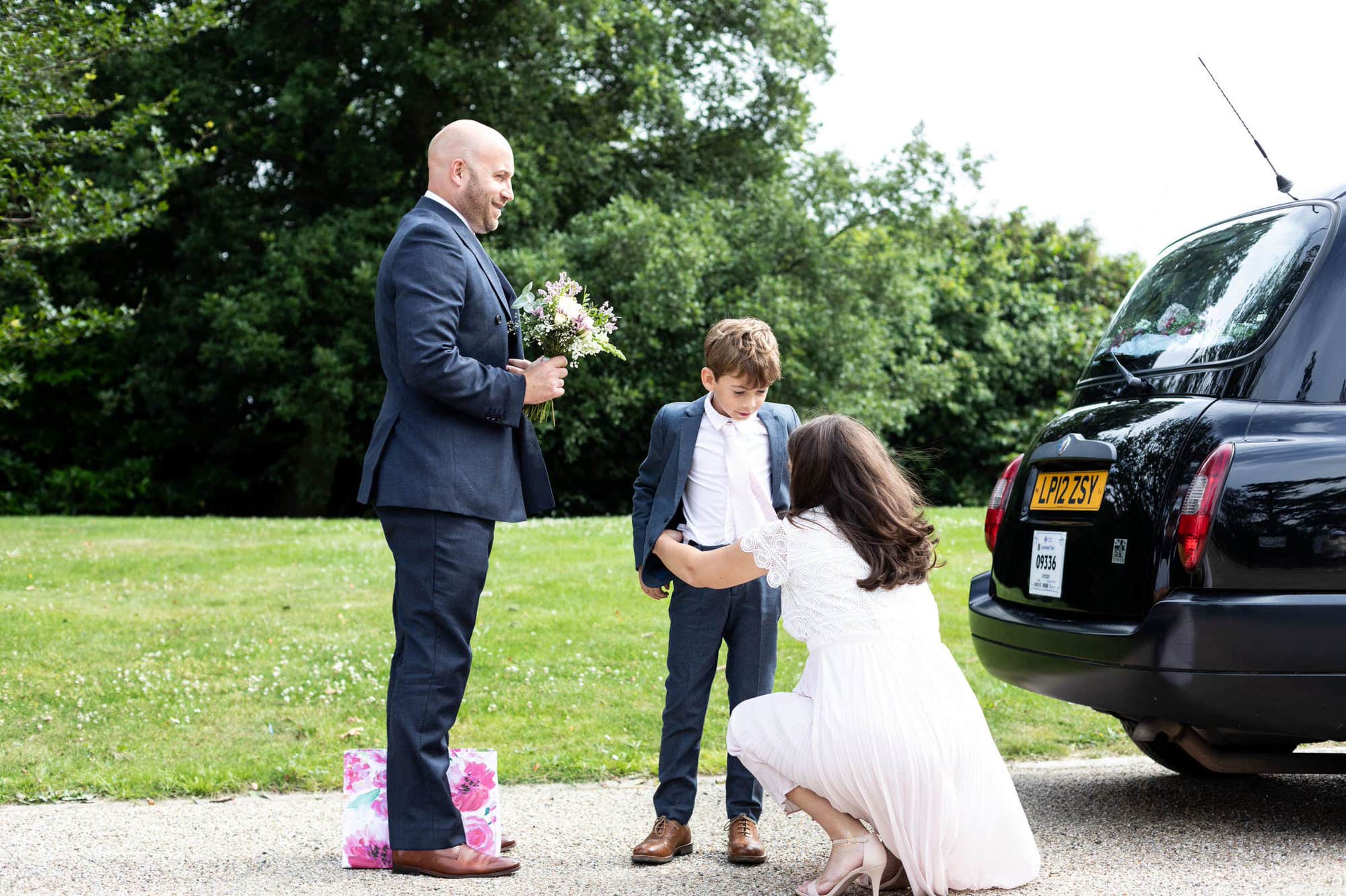 Candid image of a bride, groom and son at Kent micro wedding Danson House Bexleyheath