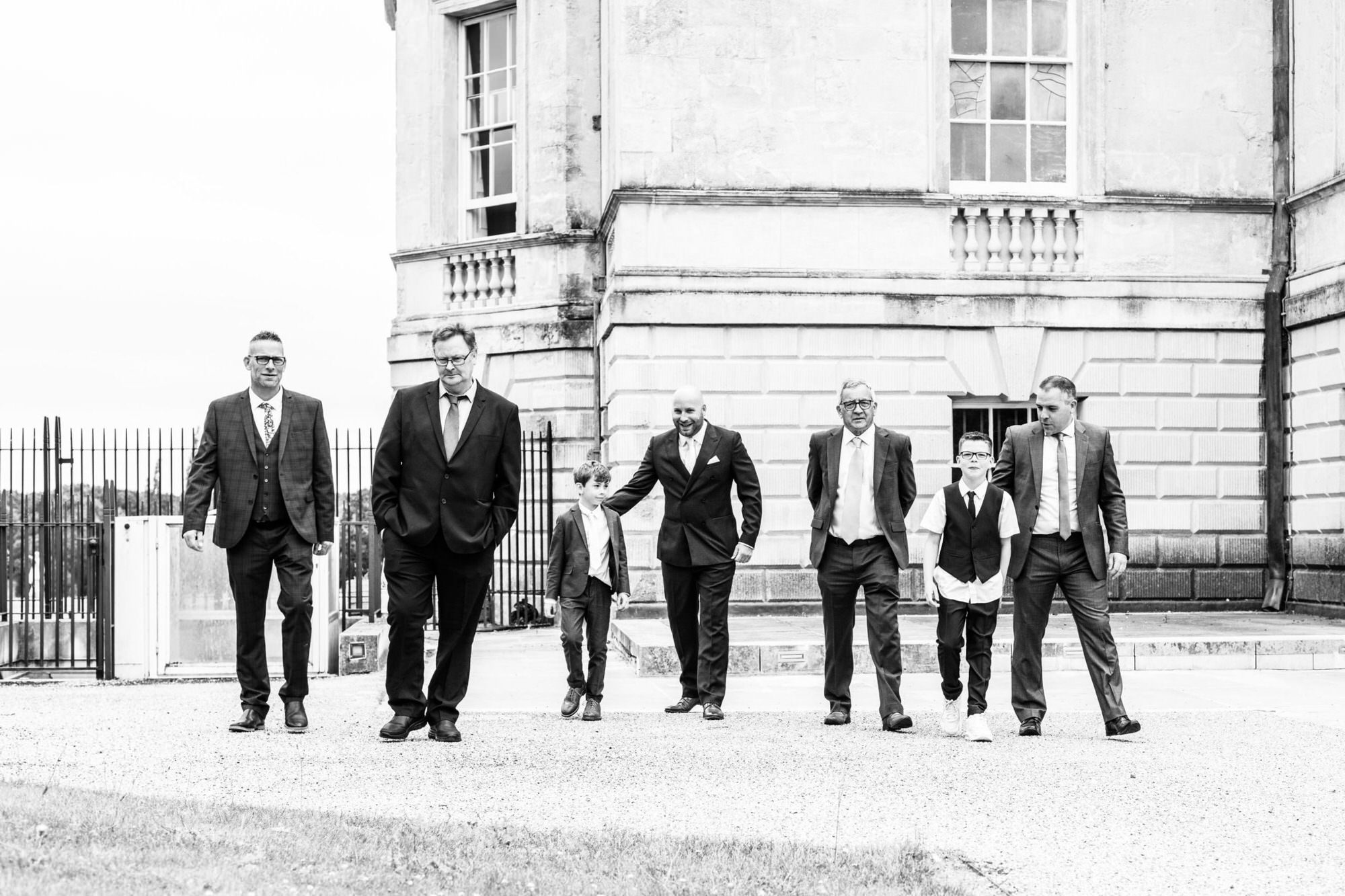 Male guests walking towards the camera shot at Kent micro wedding at Danson House Bexleyheath