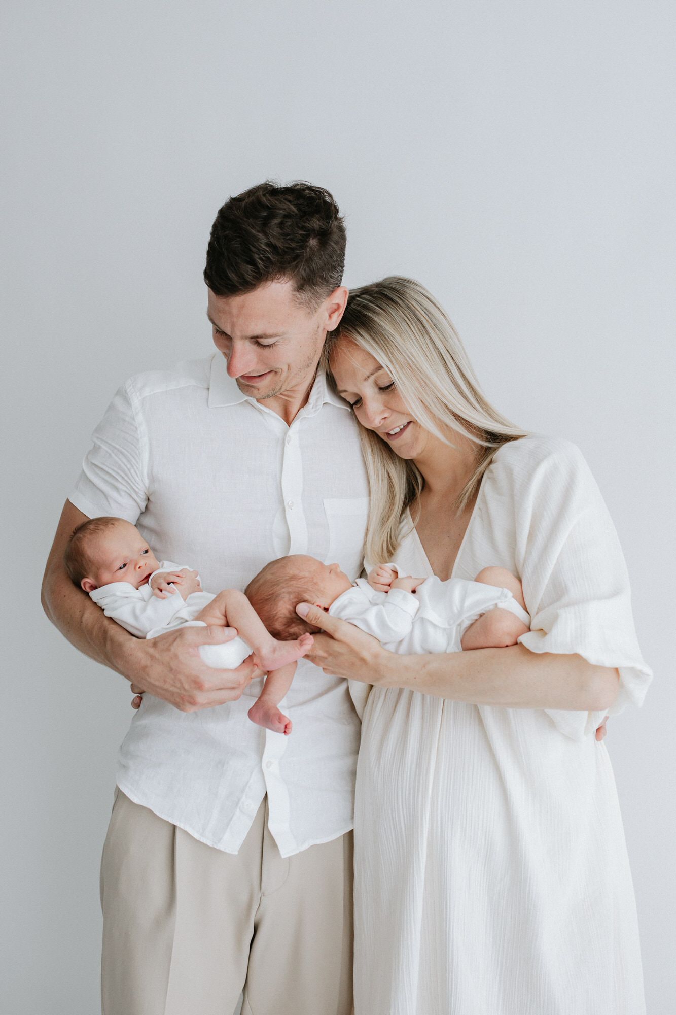 new mummy and daddy with their beautiful baby twins at their Kent newborn photoshoot in Bexley