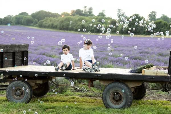 two boys sat on a tractor trailer with bubbles at their Kent Lavender photoshoot