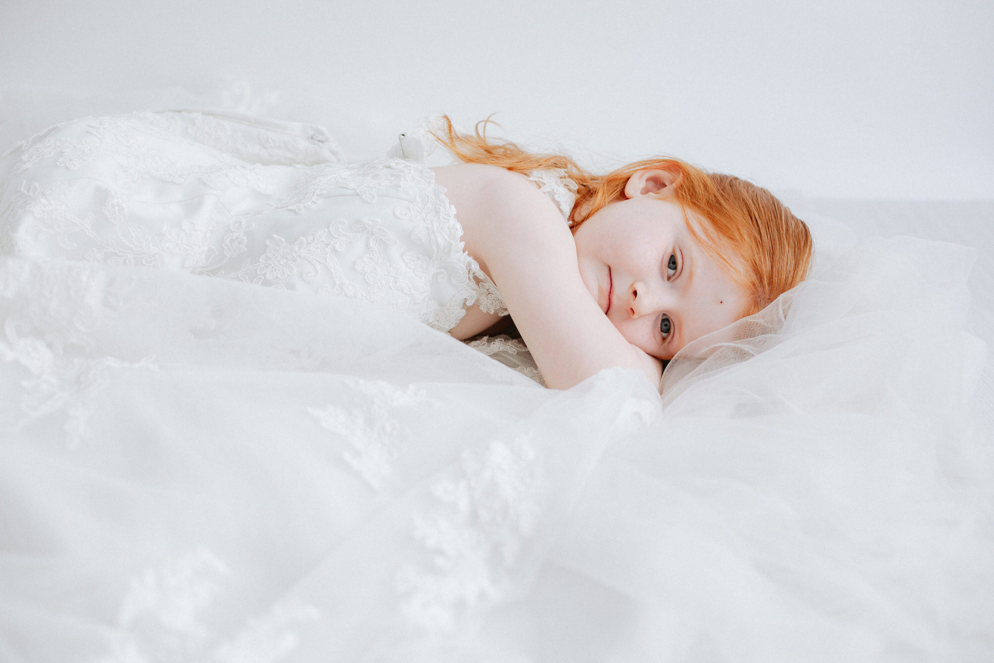 little girl in her mummy's wedding dress at her Kent photoshoot