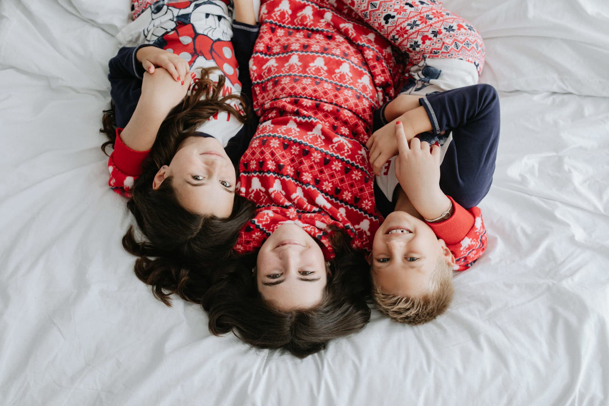 siblings shot from above in Christmas pyjamas at their Kent Christmas photoshoot in Bexley