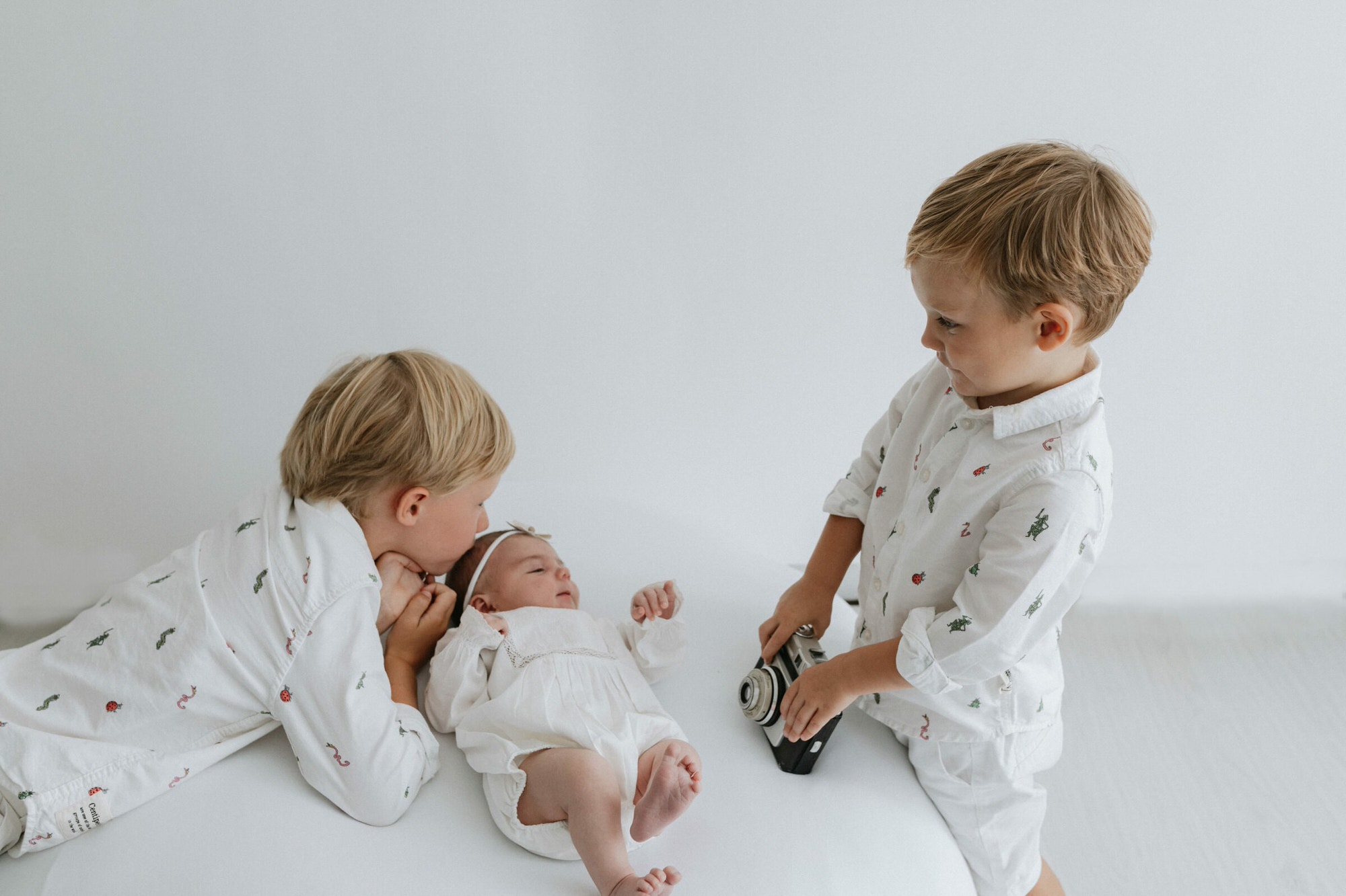 older brothers with their newborn sister at their baby photoshoot in Bexley Kent