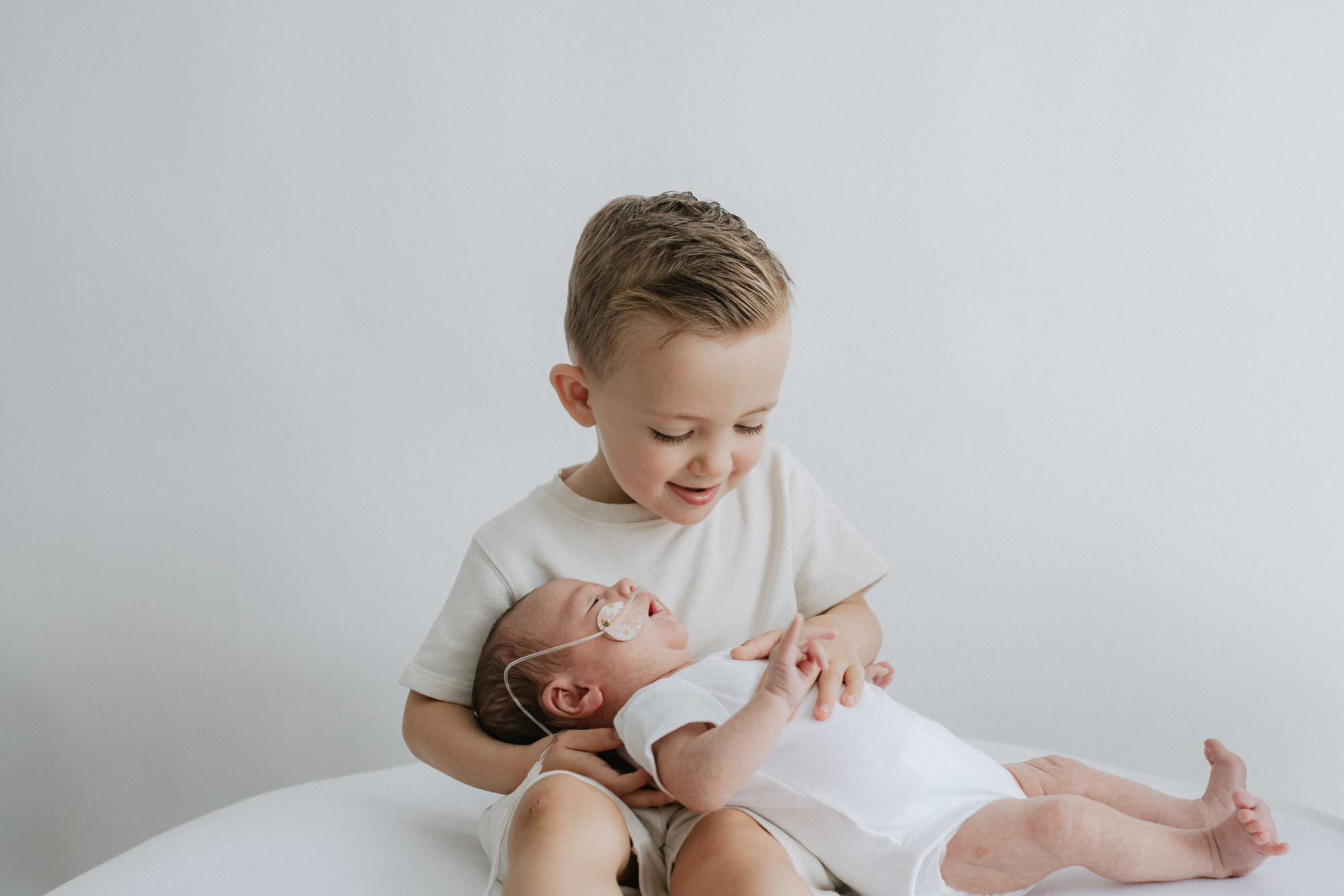 little boy with his newborn sister at their kent baby photoshoot in Bexley