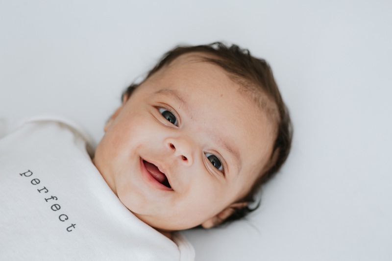 beautiful baby boy looking straight into the camera at his Kent baby photoshoot in Bexley
