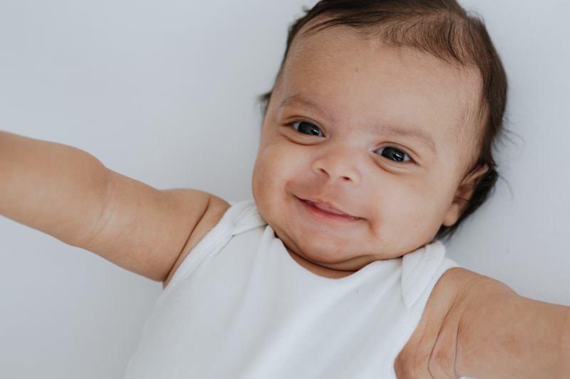 beautiful newborn baby boy smiling at his Kent baby photoshoot in Bexley