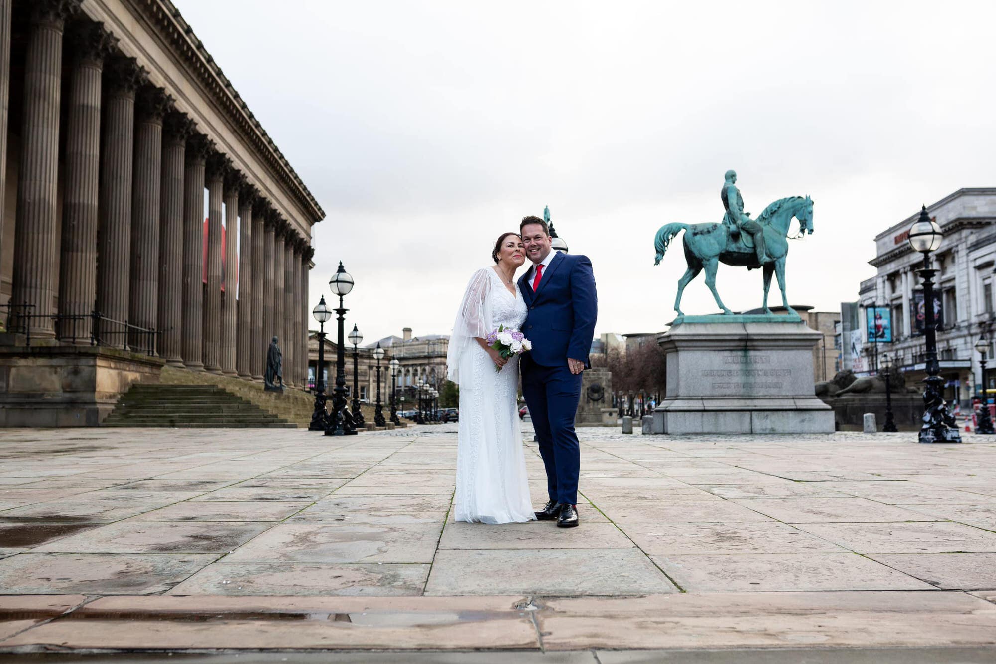 St Georges Hall Liverpool micro covid wedding bride and groom with famous statue and collums in the background