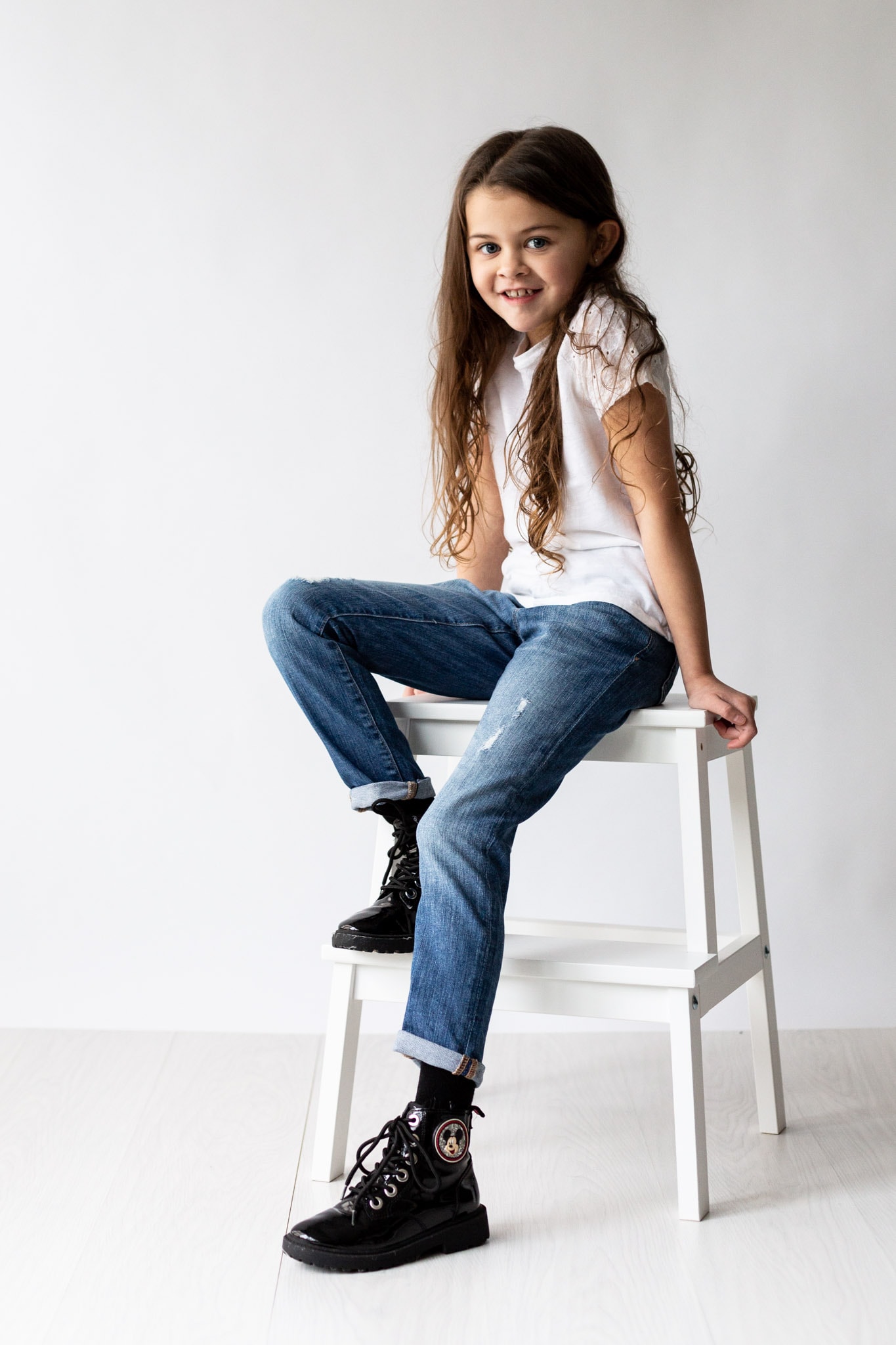 little girl sat on ikea step stall at her modelling portfolio updates shoot in bexley kent