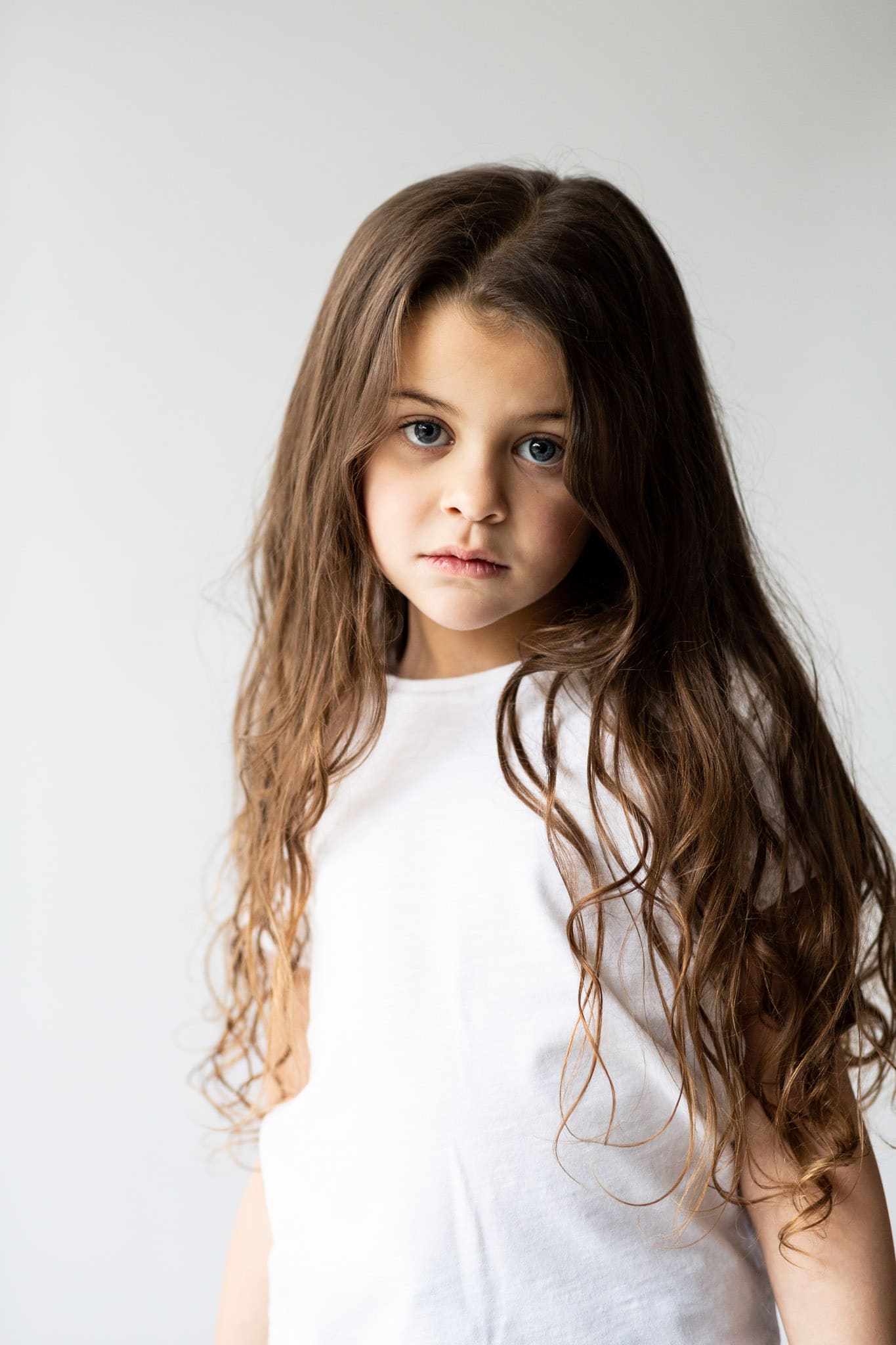 little girl looking right into the camera at her modeling portfolio updates shoot in bexley kent