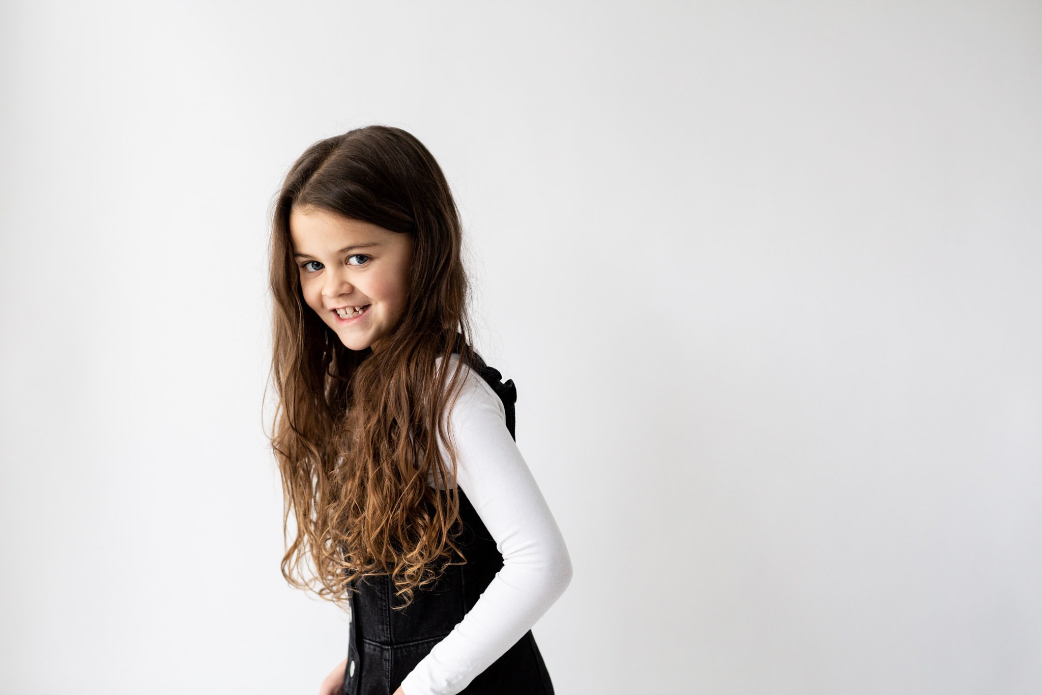 little girl laughing, hands in pockets at her kent modelling portfolio updates shoot in bexley