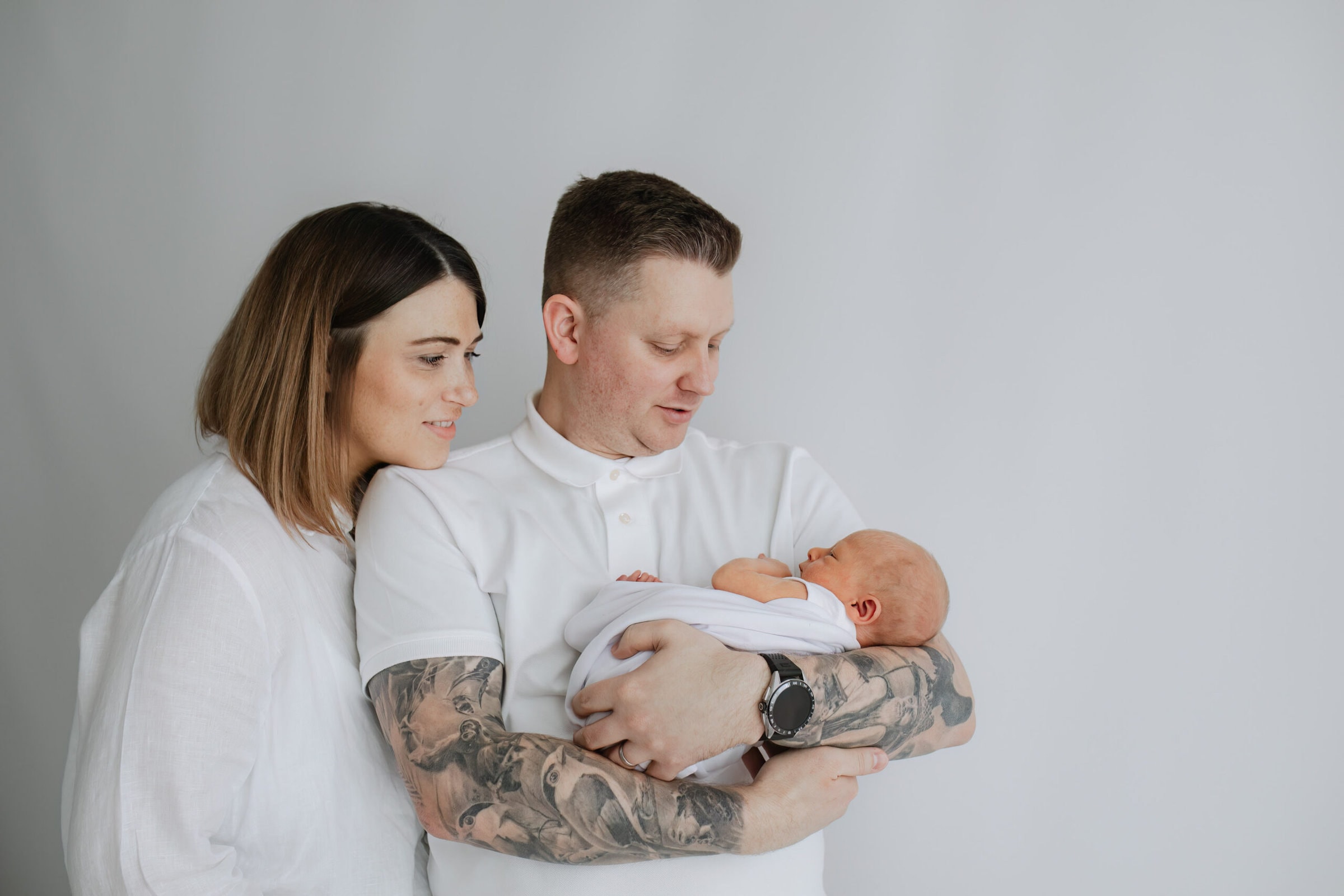 Mummy and daddy with their newborn son, at their kent baby photoshoot in bexley