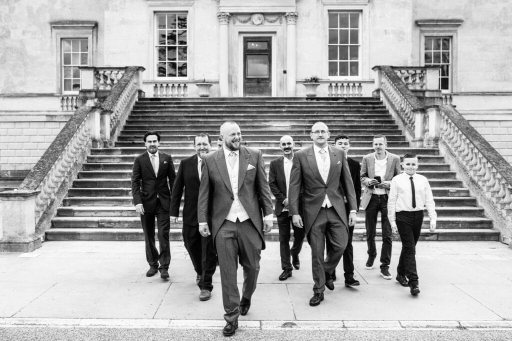 fun shot of the boys at a Danson House Wedding Bexleyheath walking towards the camera in black and white
