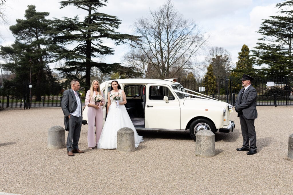 Bridal party with their white vintage wedding taxi Danson House Bexleyheath micro wedding coverage