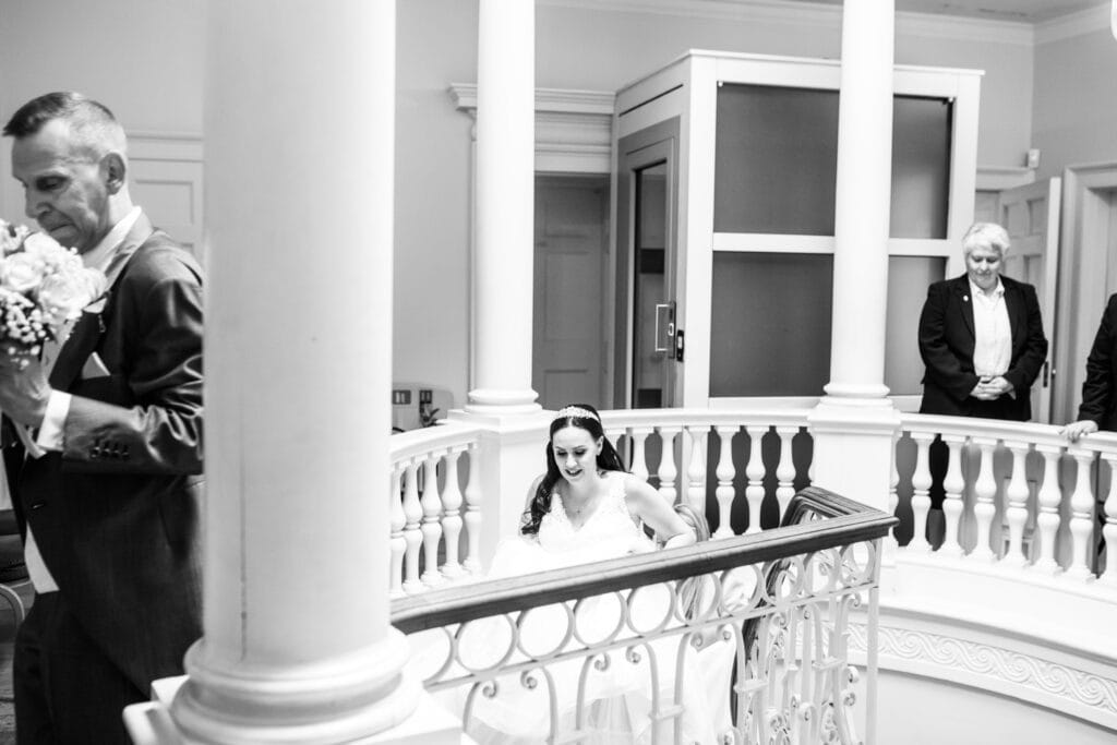 bride walking up the spiral stairs at Danson House Bexleyheath micro wedding coverage Kent