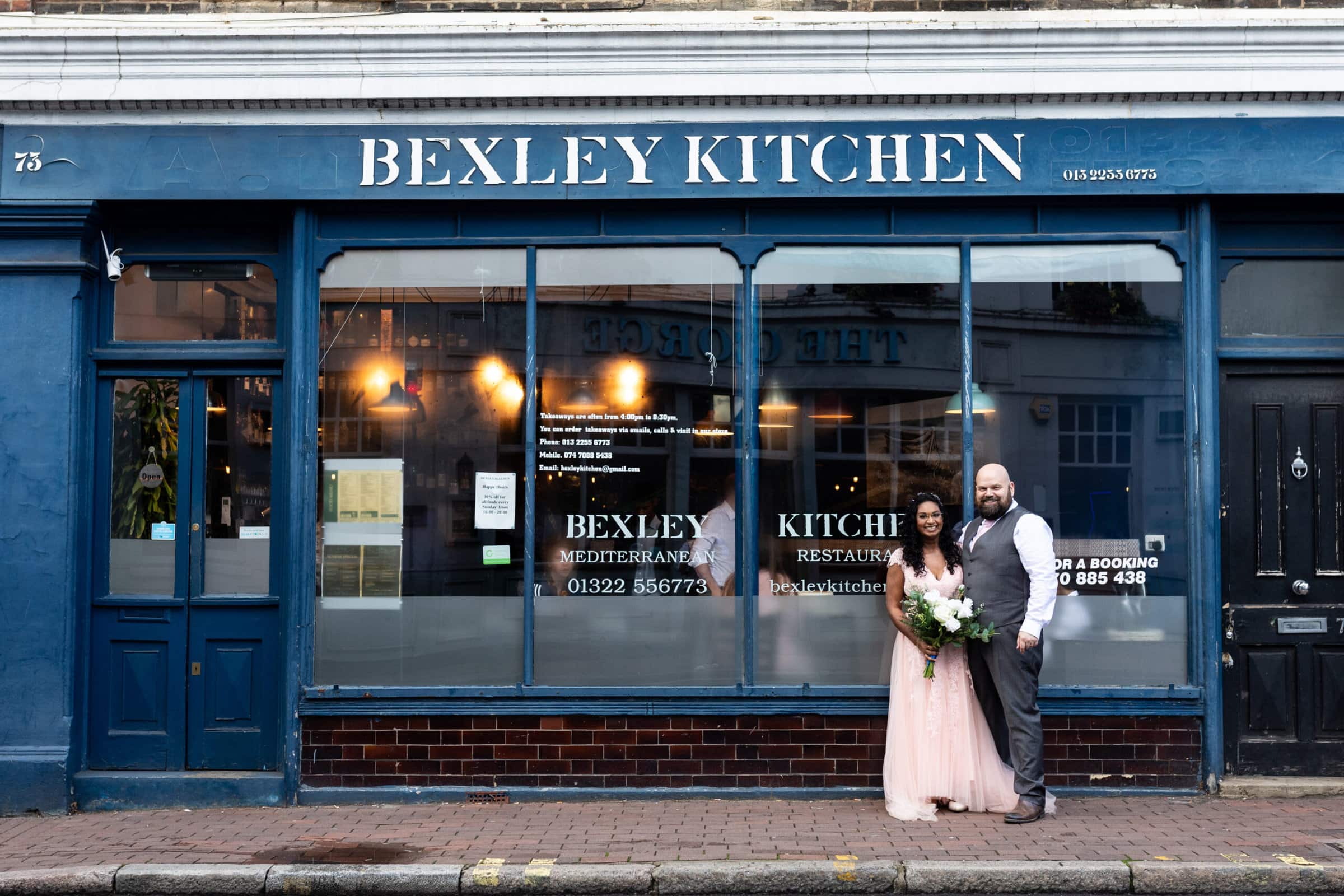 bride and groom outside Bexley kitchen on their wedding day afterparty Kent wedding photographer Nina callow